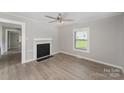 Inviting living room featuring fresh paint, a decorative fireplace, and durable laminate floors throughout at 210 Marshall St, Rock Hill, SC 29730