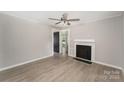 Inviting living room featuring fresh paint, a decorative fireplace, and durable laminate floors throughout at 210 Marshall St, Rock Hill, SC 29730