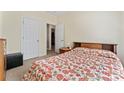 Bright bedroom with neutral walls, a floral bedspread, and easy access to a closet and hallway at 219 Mccord St, Charlotte, NC 28216