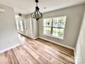 Inviting entryway showcasing light wood flooring, a modern chandelier, and an abundance of natural light at 2242 Shumard Cir, Indian Trail, NC 28079