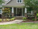 Covered front porch with stone pillars and curated decor at 237 Garvin Rd, McConnells, SC 29726