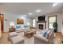 Bright living room featuring a fireplace, wood floors, and comfortable seating at 25056 Timberlake Dr, Fort Mill, SC 29708