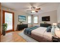 Cozy bedroom with hardwood floors, two TVs, and a door leading to the outside at 25056 Timberlake Dr, Fort Mill, SC 29708