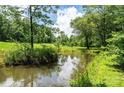 Picturesque pond reflecting the sky and surrounding trees, offering a serene natural view at 3659 Vashti Rd, Taylorsville, NC 28681