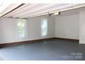 Clean and spacious two-car garage interior with painted floor and plenty of natural light at 3664 Gaston Day School Rd, Gastonia, NC 28056