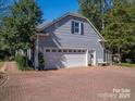 Detached two-car garage with brick driveway and easy access to the house at 3664 Gaston Day School Rd, Gastonia, NC 28056