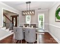 Dining room with modern lighting, hardwood floors, and elegant chair detail at 3905 Brittany Ct, Indian Trail, NC 28079