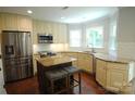 Bright kitchen features granite countertops, stainless appliances, and an island with bar stool seating at 3905 Brittany Ct, Indian Trail, NC 28079