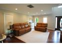 Neutral living room with hardwood floors, recessed lighting, and two plush leather couches at 3905 Brittany Ct, Indian Trail, NC 28079