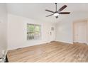 Open-concept living space with wood flooring, vaulted ceiling, large windows, and great natural light at 43 Paddington Sw Dr, Concord, NC 28025