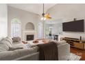 Comfortable living room featuring a fireplace, hardwood floors, and seamless flow to the dining area at 4605 Sarandon Ct, Charlotte, NC 28215