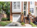 Attractive brick townhome with a single-car garage, private entrance, and well-maintained landscaping at 4854 S Hill View Dr, Charlotte, NC 28210