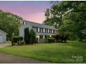 Charming two-story home with a large front yard, covered porch, and mature trees at 5632 Zion Church Rd, Concord, NC 28025