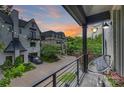 Townhome balcony view showcasing the brick driveway, neighboring homes, and string lights at 622 Mattie Rose Ln, Charlotte, NC 28204