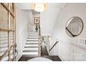Bright foyer with hardwood floors, white wainscoting, staircase, and stylish decor at 622 Mattie Rose Ln, Charlotte, NC 28204