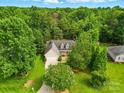 An aerial view showcases the property, surrounded by lush trees and greenery at 6530 Fly A Way Dr, Denver, NC 28037