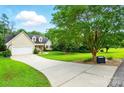View of the exterior showcasing a long driveway leading up to a well-maintained home at 6530 Fly A Way Dr, Denver, NC 28037