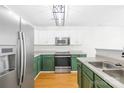 Modern kitchen featuring stainless steel appliances and green and white cabinets at 8614 Westhope St, Charlotte, NC 28216