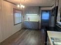 Kitchen showing cabinets, countertops, appliances, light fixture, and doorway at 9314 Seymour Ln, Davidson, NC 28036