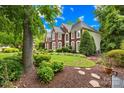 Beautiful brick home with manicured landscaping, mature trees and a serene backyard setting at 9514 Hayenridge Ct, Huntersville, NC 28078