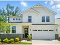 Stunning two-story home with white siding, stone accents, lush landscaping, and an attached two-car garage at 9846 Quercus Ln, Huntersville, NC 28078