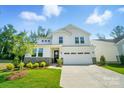 Beautiful two-story home with white siding, stone accents, well-maintained lawn, and an attached two-car garage at 9846 Quercus Ln, Huntersville, NC 28078