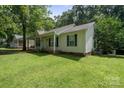 Inviting single-story home with green lawn and a welcoming front porch perfect for relaxing at 1013 Ashwood Pl, Salisbury, NC 28146