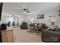 Spacious living room with a ceiling fan, comfortable gray sofas, and ample natural light at 1013 Ashwood Pl, Salisbury, NC 28146