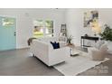 Bright, open living room with white walls and contemporary furnishings providing a comfortable space at 103 Wadesborough Pl, Wadesboro, NC 28170