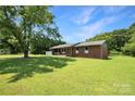 Spacious lawn surrounds this single-story brick home with a partially covered front porch and tasteful window shutters at 1145 Craigbrow Cir, Chester, SC 29706
