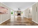 Open-concept living room with wood plank floors, a brick fireplace, and neutral wall colors at 118 Creek Hollow Trl, Belmont, NC 28012
