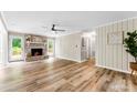 Spacious living room featuring a cozy fireplace, wood plank flooring, and bright natural light at 118 Creek Hollow Trl, Belmont, NC 28012