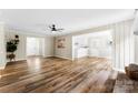 Inviting living room with wood plank flooring open to the kitchen, and neutral paint colors at 118 Creek Hollow Trl, Belmont, NC 28012