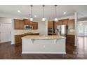 Gourmet kitchen features granite countertops, stainless steel appliances and a kitchen island at 128 Yellowbell Rd, Mooresville, NC 28117