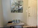 Charming entryway featuring a neutral wall, bench with accent pillows, and decorative painting at 140 Lake Concord Ne Rd, Concord, NC 28025