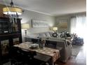 Cozy living room with a beautiful cabinet, dining table, and large couch with soft lighting at 140 Lake Concord Ne Rd, Concord, NC 28025