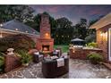 Cozy outdoor fireplace with comfortable seating and a built-in grill, perfect for enjoying evenings outdoors at 159 Carsons Pl, Mooresville, NC 28117