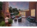 Charming outdoor patio with a stone fireplace, comfortable seating, and a built-in grill, creating an inviting space at 159 Carsons Pl, Mooresville, NC 28117