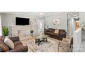 Cozy living room with a brick fireplace, comfortable seating, and tiled flooring at 1627 33Rd Ne Ave, Hickory, NC 28601