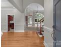 Bright foyer with hardwood floors, arched doorway, and staircase leading to the upper level at 165 Futrell Lndg, New London, NC 28127