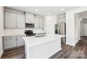Modern kitchen with stainless steel appliances, a center island, and white cabinets at 2125 Rolling Hills Ct, Stanley, NC 28164