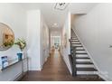 Bright hallway features hardwood floors, a staircase, and modern decor at 2600 Mason Cir # A, Charlotte, NC 28205