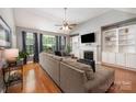 Bright living room with a fireplace, vaulted ceilings, built-in shelving, and large windows at 2804 Pulaski Dr, Monroe, NC 28110