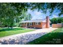 Classic brick ranch-style home with a long driveway and well-kept lawn at 306 2Nd Avenue Ne Pl, Conover, NC 28613