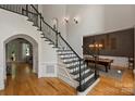 Open foyer with hardwood floors, grand staircase, and adjacent dining room at 3284 Millstone Creek Rd, Lancaster, SC 29720