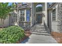 Elegant covered front entry with stone steps and decorative glass door at 3284 Millstone Creek Rd, Lancaster, SC 29720