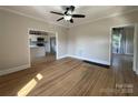 Open living room showcasing hardwood floors and view into renovated kitchen at 339 Mayflower Ave, Cramerton, NC 28032