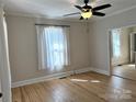 Bright living room with hardwood floors, ceiling fan, and natural light at 339 Mayflower Ave, Cramerton, NC 28032