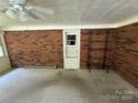 Spacious sunroom featuring brick walls, ceiling fan, and access to the outdoors at 34393 Springdale Dr, New London, NC 28127