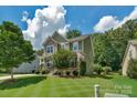 Beautifully landscaped two-story home with a charming front porch and well-maintained lawn on a sunny day at 3701 Methodist Church Ln, Waxhaw, NC 28173